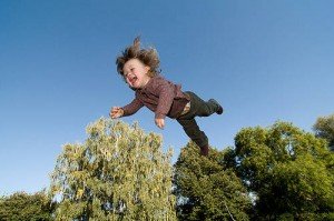 Young boy flying through the air